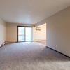 A living room with a glass sliding door Newgate Apartments |Bismarck, ND