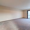 A living room with a sliding glass door Newgate Apartments |Bismarck, ND