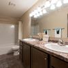a bathroom with two sinks, a toilet, and a bathtub Newgate Apartments |Bismarck, ND