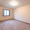 a bedroom with a small window Newgate Apartments |Bismarck, ND