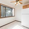 A dining room with a fridge and window  Riverpark Apartments | Bismarck, ND