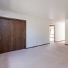 A living room with a closet and window  Riverpark Apartments | Bismarck, ND