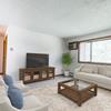 Living room with television, couches, coffee table, and window |Arbor 400 Bismarck, ND