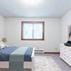 Bedroom with bed, dresser, and window|Arbor 400 Bismarck, ND