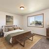 Bedroom iwith a bed, dresser, nightstands, and window| Brentwood II Bismarck, ND