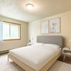 Bedroom with white bedding, and a window | Brandon Bismarck, ND