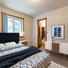 Bedroom with blue and white bedding on the bed and a window  | Brandon Bismarck, ND