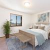 a bedroom with a bed, nightstands, and a window Fairview | Bismarck, ND