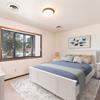  Bismarck, ND Riverpark Apartments  a bedroom with a large window and a large bed with blue bedding