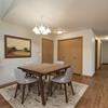  Bismarck, ND Sierra Ridge Apartments. The room showcases a modern dining table with four elegant chairs, well-placed lighting, and a sophisticated ambiance for enjoyable meals and gatherings.
