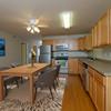  Fargo, ND Thunder Creek Apartments. A modern and well-equipped kitchen and dining area.. The space features sleek appliances, a spacious dining table, and tasteful decor, creating an inviting and functional environment for cooking and dining
